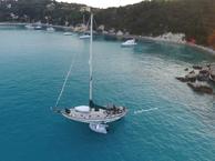 sail boat anchored in a cove